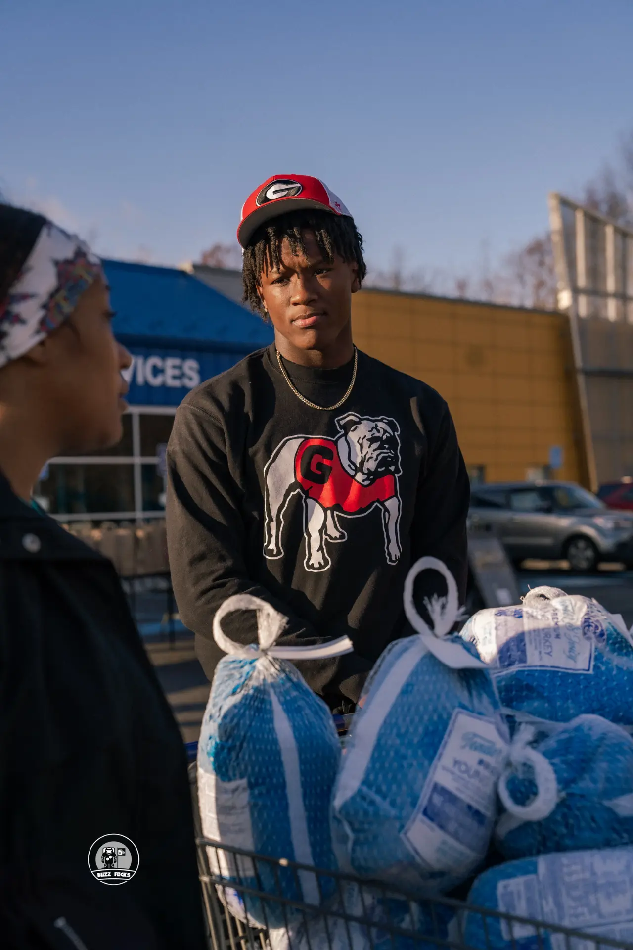 Chris Cole loading a cart of turkeys with a volunteer at the food drive