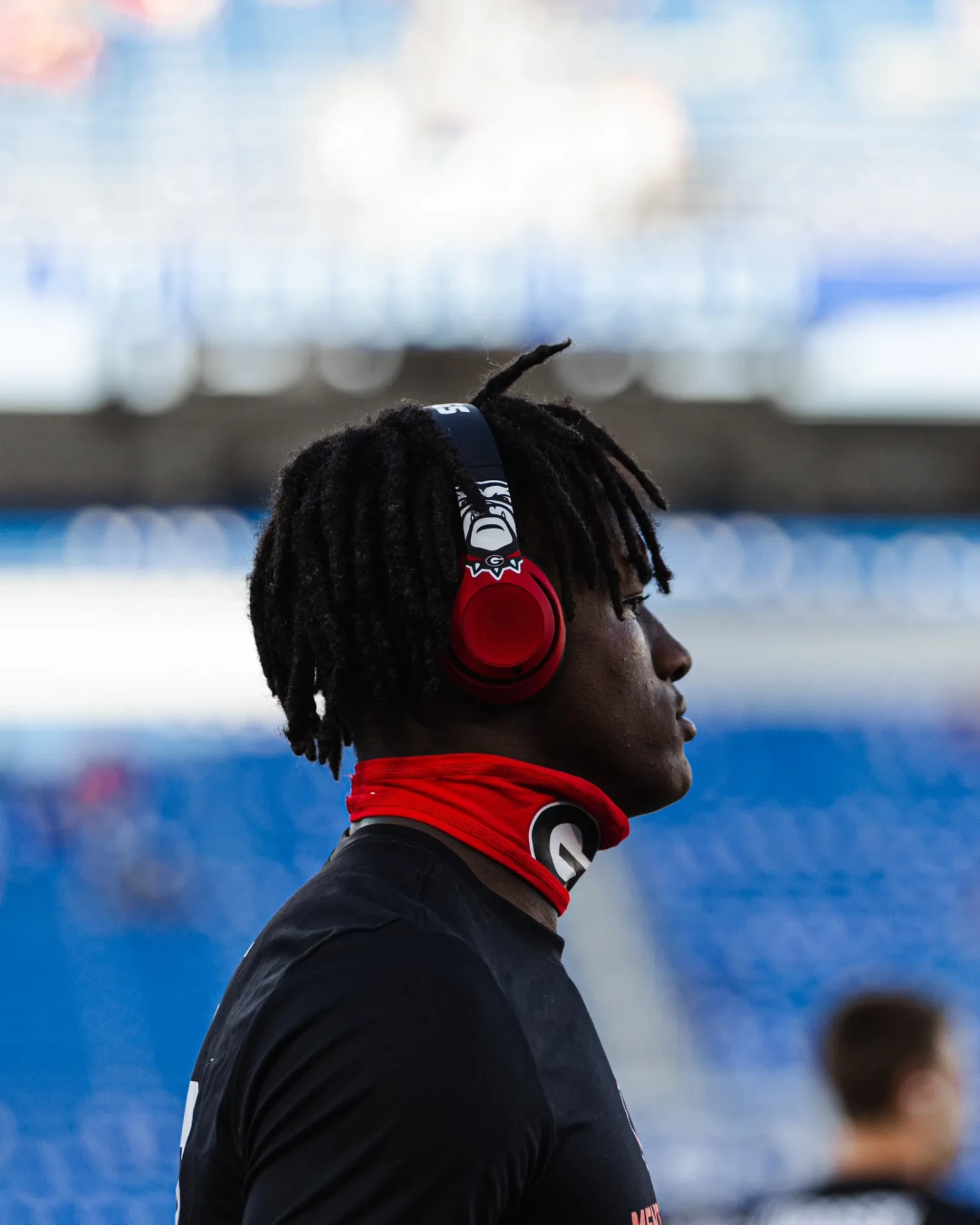 Chris Cole in profile wearing Georgia Bulldogs headphones before a game